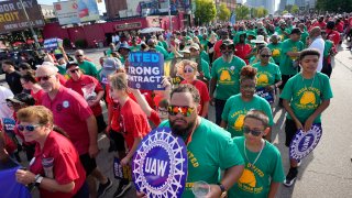 File - United Auto Workers members walk in the Labor Day parade