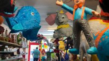 Francisco Rodríguez looks out the window of his shop Casa de Piñatas in Albuquerque, N.M., Sept. 7, 2023. Rodríguez said many older piñata artists have retired but he's hopeful the next generation will take an interest in the craft. On Friday, Sept. 8, the U.S. Postal Service released its latest collection of special stamps, this time highlighting the piñata as part of a monthlong recognition of Hispanic heritage in the U.S. (AP Photo/Susan Montoya Bryan)