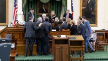 Attorneys gather around Lt. Gov. Dan Patrick during Day 7 of the Ken Paxton impeachment trial in Austin, Texas, Wednesday, Sept. 13, 2023.