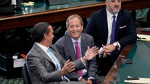 Suspended Texas state Attorney General Ken Paxton, center, talks with this attorneys Tony Buzbee, left, and Mitch Little, right, before closing arguments in his impeachment trial in the Senate Chamber at the Texas Capitol, Friday, Sept. 15, 2023, in Austin, Texas. 