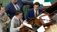 Prosecutor Daniel Dutko, bottom left, and defense attorney Anthony Osso, discuss the admission of evidence with presiding judge Lt. Gov. Dan Patrick on Day 8 of the Ken Paxton impeachment trial, Thursday, Sept. 14, 2023, in Austin, Texas.