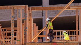 Construction employees work in a multifamily housing project in San Diego, California, September 19, 2023.