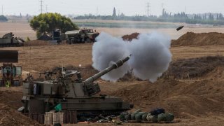 An Israeli army self-propelled howitzer fires rounds towards the Gaza Strip from southern Israel on October 12, 2023.