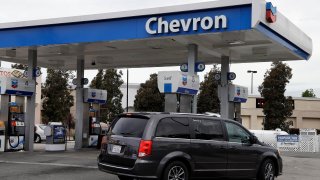 A motorist drives near the pumps at a Chevron gas station in Oakland, Calif., on April 25, 2017. Chevron is buying Hess Corp. for $53 billion as the biggest U.S. oil companies use a recent windfall in profits to buy up smaller competitors, Chevron said in a press release Monday, Oct. 23, 2023.