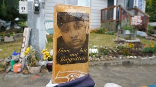 A sign is displayed on May 27, 2021, at a memorial in Tacoma, Wash., where Manuel "Manny" Ellis died