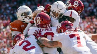 The Oklahoma defense stands up Texas running back Jonathon Brooks on a key goal line stand during the second half of an NCAA college football game at the Cotton Bowl, Saturday, Oct. 7, 2023, in Dallas. Oklahoma won 34-30. (AP Photo/Jeffrey McWhorter)