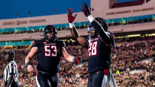 LUBBOCK, TEXAS – OCTOBER 14: Tahj Brooks #28 of the Texas Tech Red Raiders celebrates with Rusty Staats #53 after scoring a touchdown during the first half of the game against the Kansas State Wildcats at Jones AT&T Stadium on October 14, 2023 in Lubbock, Texas.