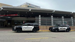 Police vehicles sit outside a hospital in Robbinsdale, Minn., Oct. 12, 2023, after five officers were shot near the nearby town of Princeton.
