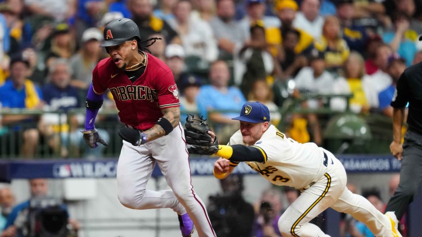 Josh Donaldson of the Milwaukee Brewers tags out Ketel Marte of the Arizona Diamondbacks at home in the sixth inning during Game 2 of the Wild Card Series between the Arizona Diamondbacks and the Milwaukee Brewers at American Family Field on Wednesday, Oct. 4, 2023, in Milwaukee.