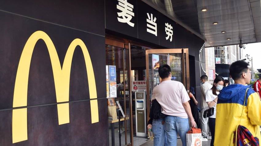 Customers wait for their takeout food outside a McDonald’s restaurant during the May Day holiday on May 1, 2022 in Beijing, China.