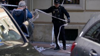 A police officer cordons off the area after a shooting in Madrid, Spain, Nov. 9, 2023.