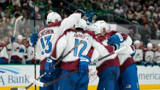 Colorado Avalanche players celebrate a power play goal by Ryan Johansen (12) during the second period of an NHL hockey game against the Dallas Stars, Saturday, Nov. 18, 2023, in Dallas. (AP Photo/Julio Cortez)