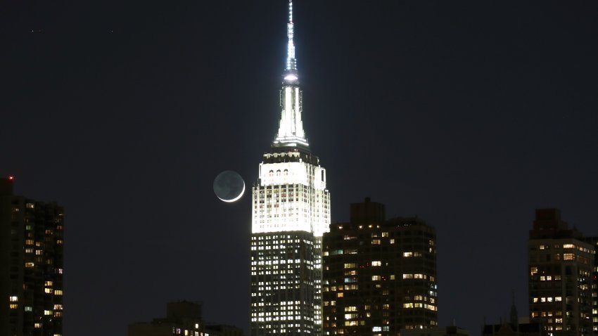 NEW YORK, NY – MARCH 29: A crescent moon sets behind the east side of Manhattan and the Empire State Building on March 29, 2017 in New York City.