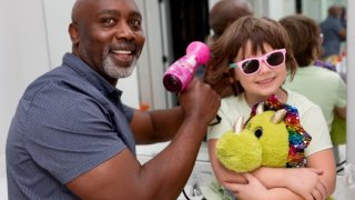 Peter Mutabazi with Skylar, one of the children he has adopted.