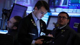 Traders work on the floor at the New York Stock Exchange (NYSE) in New York City, U.S., December 1, 2023.
