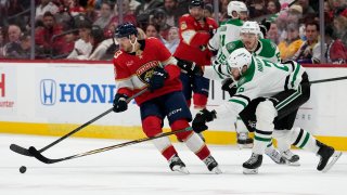 Florida Panthers center Sam Reinhart (13) skates with the puck as Dallas Stars defenseman Jani Hakanpaa (2) defends during the second period of an NHL hockey game, Wednesday, Dec. 6, 2023, in Sunrise, Fla.