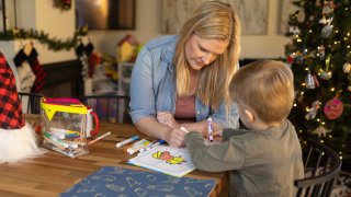 Kaitlyn Kash uses a coloring book with her 5-year-old son at home, Sunday, Dec. 17, 2023, in Austin, Texas. Kash has joined as a plaintiff on the Zurawski v. State of Texas case, a lawsuit that looks to clarify the scope of the state’s abortion ban. (AP Photo/Stephen Spillman)