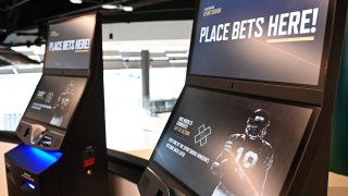 Betting kiosks are seen inside Caesars Sportsbook inside Rocket Mortgage FieldHouse, Thursday, Dec. 29, 2022, in Cleveland. Legalized sports betting continued its expansion in 2023 with six states either passing legislation or beginning to accept wagering, Fanatics got into the business and professional leagues and college athletics continued to further embrace the industry. (AP Photo/David Dermer, File)