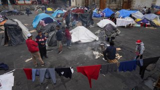 Migrants camp in tents outside the Church of Santa Cruz y La Soledad in Mexico City, Tuesday, Dec. 26, 2023. (AP Photo/Marco Ugarte)