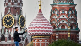 A man makes a selfie photo in front of the Kremlin’s Spasskaya tower and St. Basil’s cathedral in downtown Moscow on September 11, 2023. Russia’s Elections Commission said that the pro-Kremlin United Russia part had won local elections in four regions of Ukraine occupied by Russian forces, in a vote dismissed by Kyiv. (Photo by Alexander NEMENOV / AFP) (Photo by ALEXANDER NEMENOV/AFP via Getty Images)