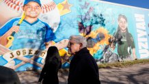 Attorney General Merrick Garland, right, and Associate Attorney General Vanita Gupta, left, tour murals of shooting victims, Wednesday, Jan. 17, 2024, in Uvalde, Texas. The Justice Department is planning this week to release findings of an investigation into the 2022 school shooting.