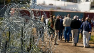 FILE – Concertina wire lines the path as members of Congress tour an area near the Texas-Mexico border, Jan. 3, 2024, in Eagle Pass, Texas. A divided Supreme Court on Monday, Jan. 22, allowed Border Patrol agents to cut razor wire that Texas installed on the U.S.-Mexico border, while a lawsuit over the wire continues. (AP Photo/Eric Gay, File)