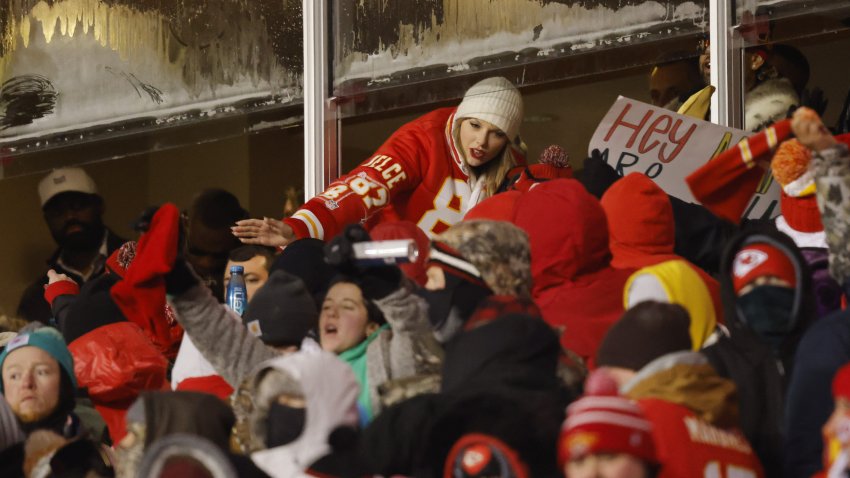 Taylor Swift celebrates with fans during the AFC wild-card game between the Miami Dolphins and the Kansas City Chiefs at GEHA Field at Arrowhead Stadium on Jan. 13, 2024, in Kansas City, Missouri.