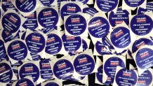 Campaign stickers sit on a table during a rally with former President Donald Trump at Simpson College on Jan. 14, 2024 in Indianola, Iowa. 