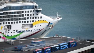 The first cruise ship, ‘Norwegian Dawn’ to arrive at Portland Port since the arrival of the Bibby Stockholm immigration barge, is seen docking, on July 26, 2023 in Portland, England.