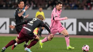 Inter Miami's Lionel Messi, right, battles for the ball against Vissel Kobe's Nanasei Iino.