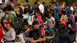 FILE – Migrants wait to be processed by the U.S. Customs and Border Patrol after they crossed the Rio Grande and entered the U.S. from Mexico, Oct. 19, 2023, in Eagle Pass, Texas.