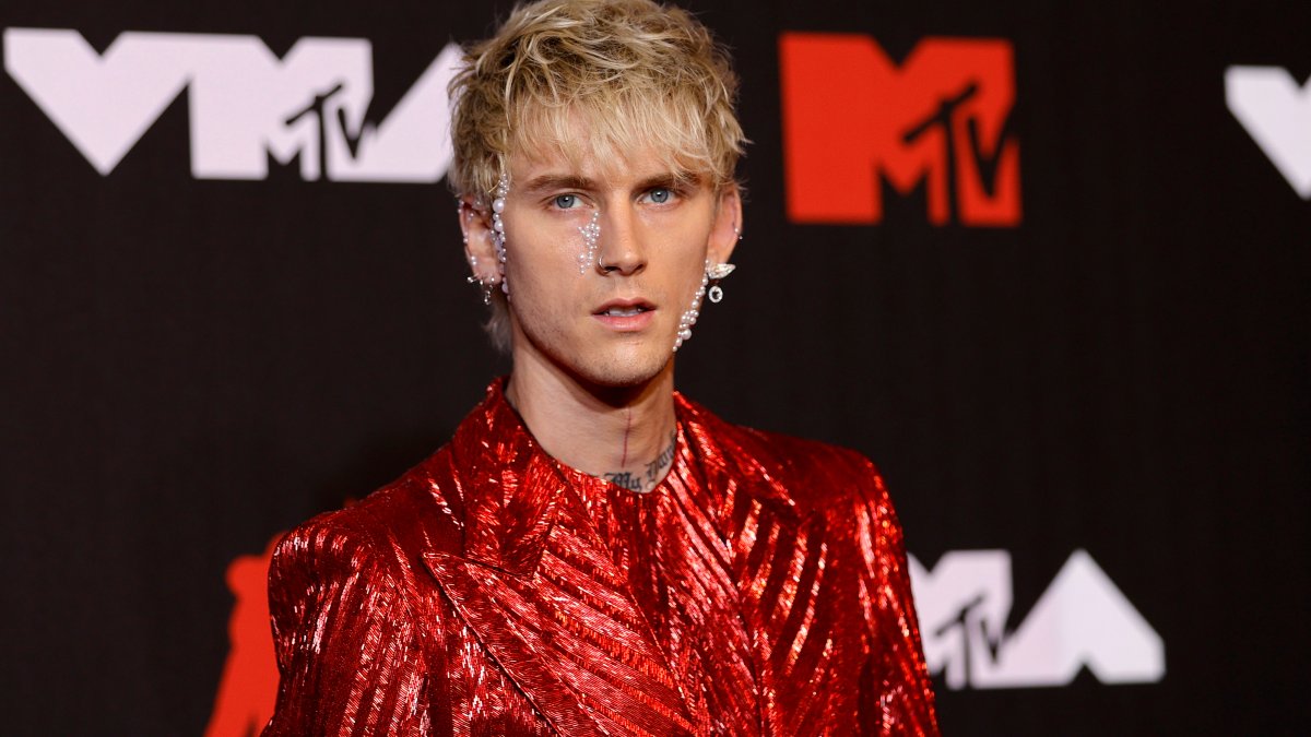 Machine Gun Kelly debuts new look after covering tattoos in black ink