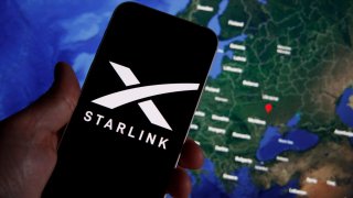 The Starlink photo is seen on a mobile device with Ukraine on a map in the background in this illustration photo in Warsaw, Poland on 21 September, 2022.