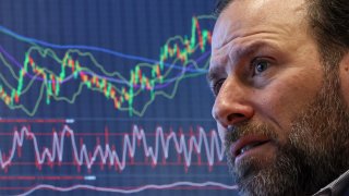 Traders work on the floor at the New York Stock Exchange on March 13, 2024.