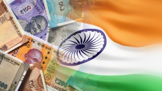 An undated editorial illustration of the Indian rupee and the Indian flag.