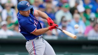 Texas Rangers’ Wyatt Langford connects for a run-scoring single against the Chicago Cubs during the fourth inning of a spring training baseball game Sunday, March 17, 2024, in Mesa, Ariz.