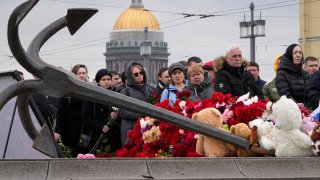 People lay flowers at a spontaneous memorial in memory of the victims of Moscow attack in St. Petersburg, Russia, Sunday, March 24, 2024. Russia observed a national day of mourning on Sunday, two days after an attack on a suburban Moscow concert hall that killed over 130 people. (AP Photo/Dmitri Lovetsky)
