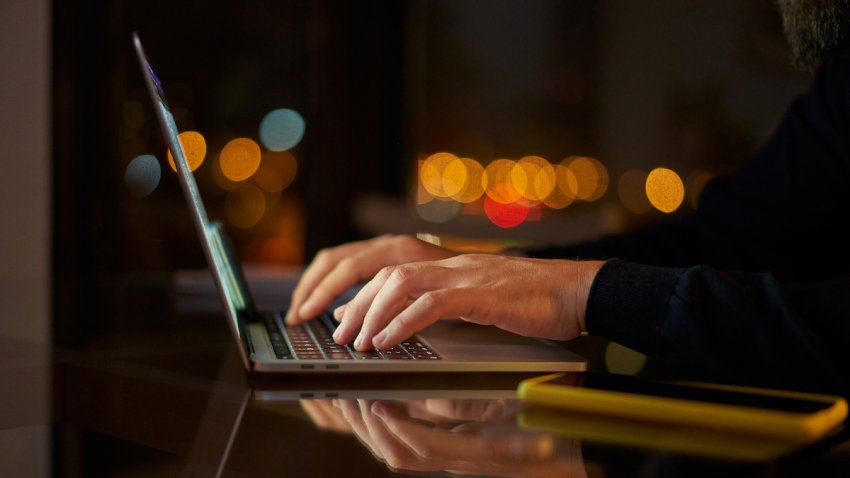 File – Man typing on laptop