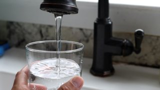 In this photo illustration, water flows from a tap on July 06, 2023 in San Anselmo, California. According to a study by the US Geological Survey, nearly half of the tap water in the United States is contaminated with “forever chemicals” that are considered dangerous to human health.
