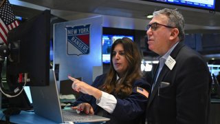 Traders work on the floor during morning trading at the New York Stock Exchange on Jan. 31, 2024.