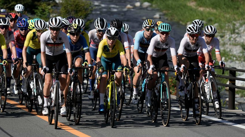 A peloton of riders compete in a road race