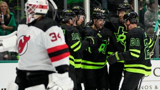 Dallas Stars’ Ty Dellandrea (10), Radek Faksa, left rear second from left, Craig Smith, center rear, Jani Hakanpaad, right rear, and Ryan Suter (20) celebrate after Smith scored in the first period of an NHL hockey game against New Jersey Devils’ Jake Allen (34) in Dallas, Thursday, March 14, 2024. (AP Photo/Tony Gutierrez)