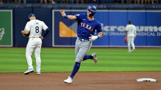 Texas Rangers’ Josh Jung waves to the Texas bullpen as he circles the bases after hitting a three-run home run off Tampa Bay Rays starter Ryan Pepiot during the first inning of a baseball game Monday, April 1, 2024, in St. Petersburg, Fla. (AP Photo/Steve Nesius)