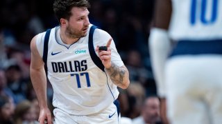 Dallas Mavericks guard Luka Doncic (77) reacts after making a shot during the first half of an NBA basketball game against the Charlotte Hornets Tuesday, April 9, 2024, in Charlotte, N.C.