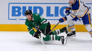 Dallas Stars center Joe Pavelski (16) reaches for the puck next to Buffalo Sabres center Tyson Jost (17) during the first period an NHL hockey game in Dallas, Tuesday, April 9, 2024.