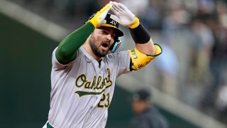 Oakland Athletics’ Shea Langeliers celebrates his two-run home run against the Texas Rangers during the ninth inning of a baseball game in Arlington, Texas, Tuesday, April 9, 2024.