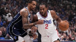 Dallas Mavericks forward P.J. Washington, left, defends as Los Angeles Clippers’ Kawhi Leonard (2) works to the basket during the first half of Game 2 of an NBA basketball first-round playoff series Friday, April 26, 2024, in Dallas. (AP Photo/Tony Gutierrez)