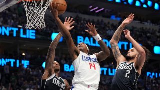 Los Angeles Clippers guard Terance Mann (14) drives to the basket past Dallas Mavericks forward P.J. Washington , left, and center Dereck Lively II (2) during the first half of Game 4 of an NBA basketball first-round playoff series Sunday, April 28, 2024, in Dallas. (AP Photo/Jeffrey McWhorter)