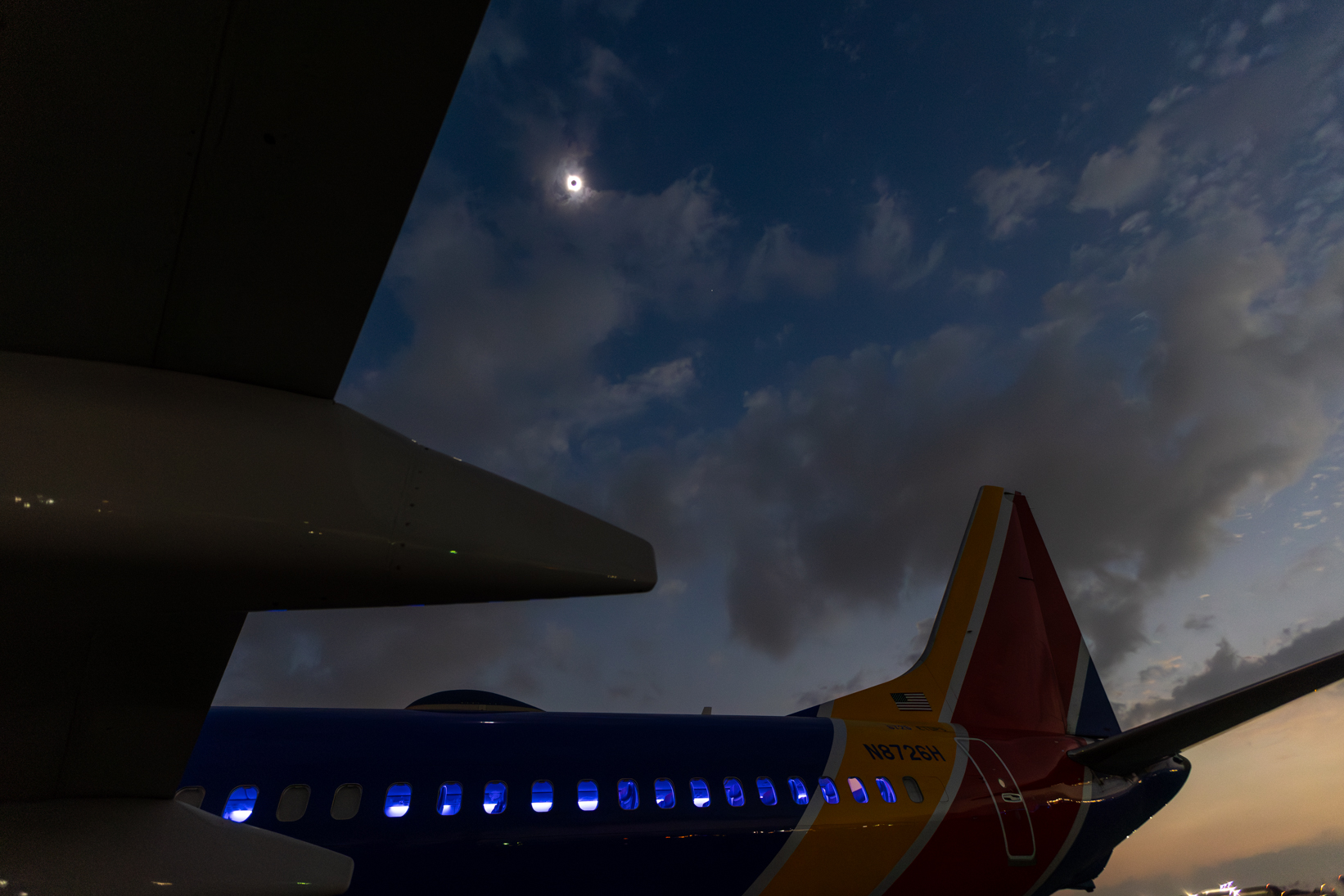 Southwest Airlines employees watch the total solar eclipse on the ramp of Dallas Love Field in Dallas, Texas on April 8, 2024. Photo by Schelly Stone