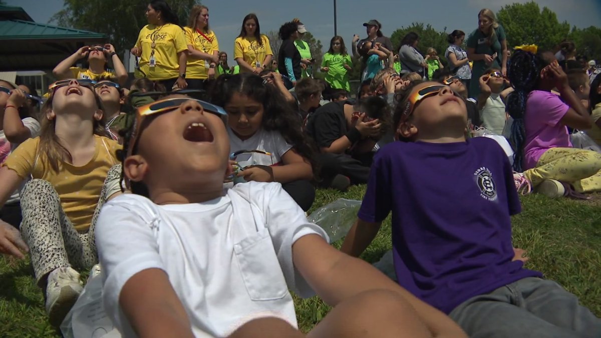 Students scream with joy as crystal clear view of eclipse opens up